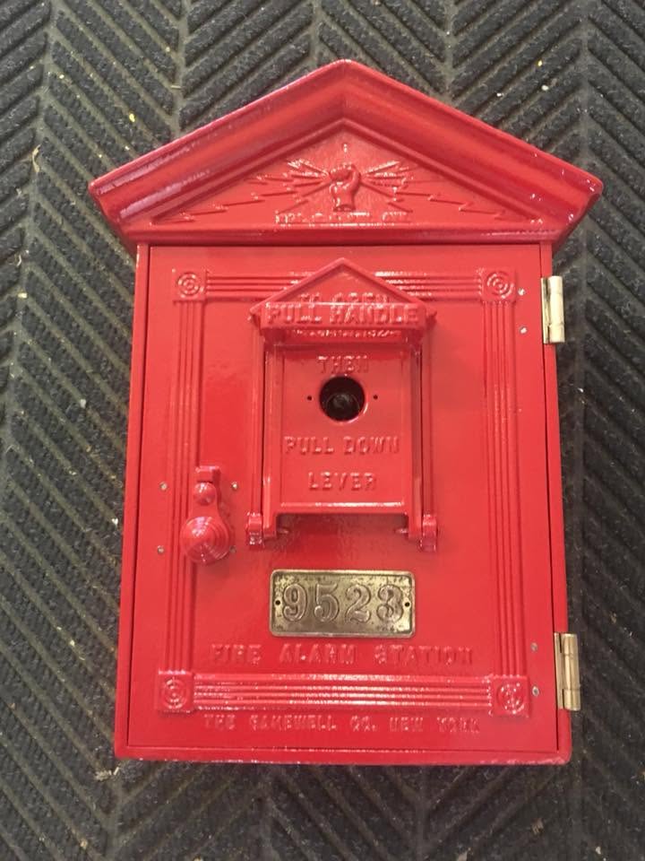 Antique cast-iron fire alarm box after powder coating, glossy fire-engine red