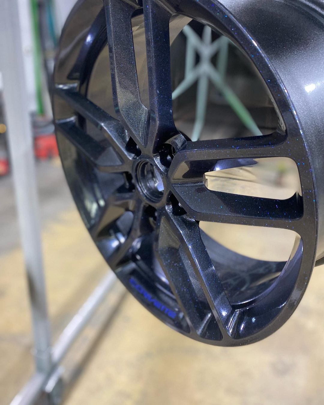 Custom multi-spoke wheel powder-coated gloss black by Superior Powder Coating